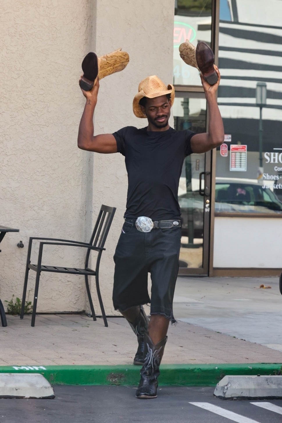 Lil Nas X is all smiles after picking up a pair of his cowboy boots from a shoe repair store in Studio City, Calif.
