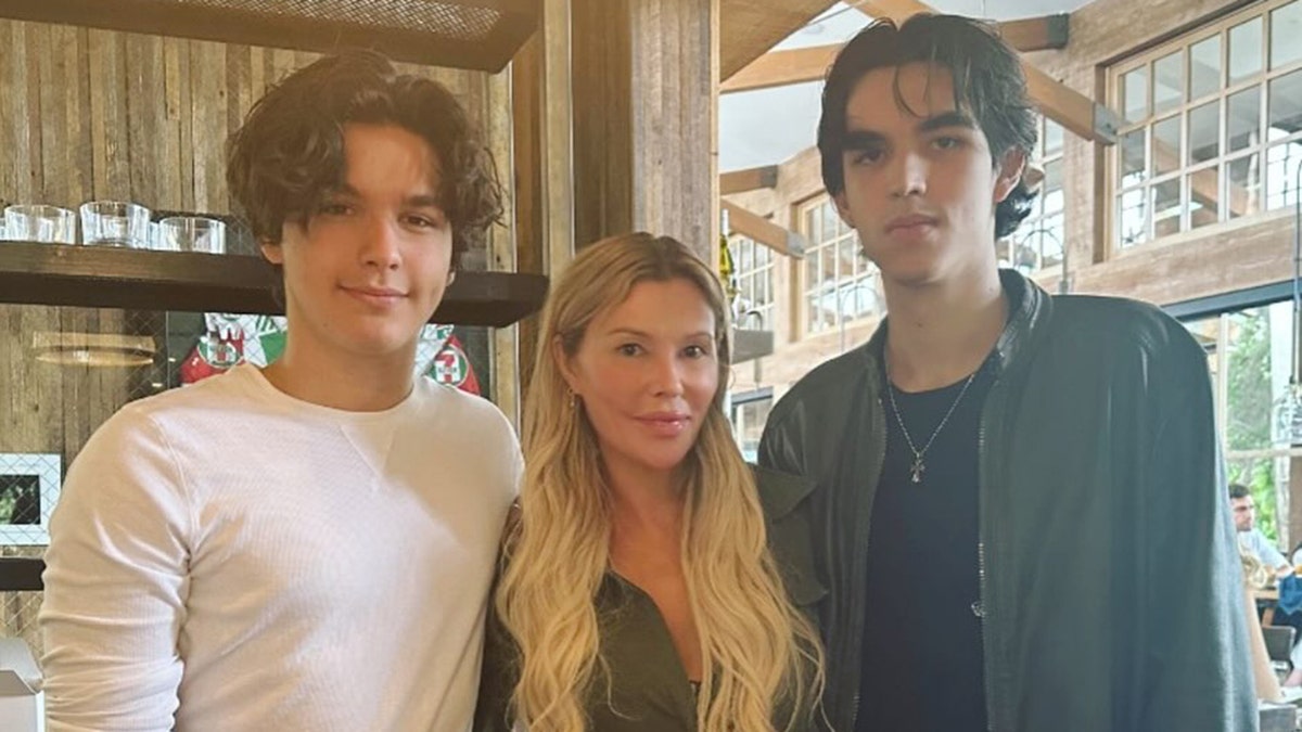 Brandi Glanville standing between her two sons Jake Austin and Mason