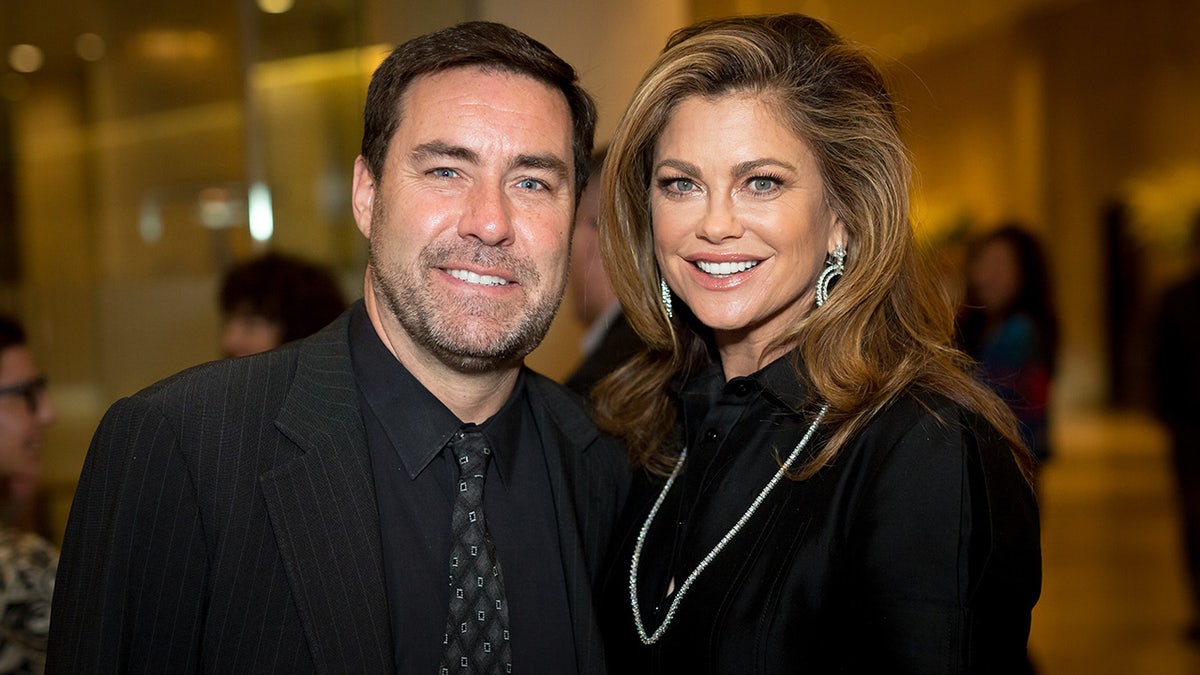 Stephen Roseberry and Kathy Ireland standing together at a gala event.