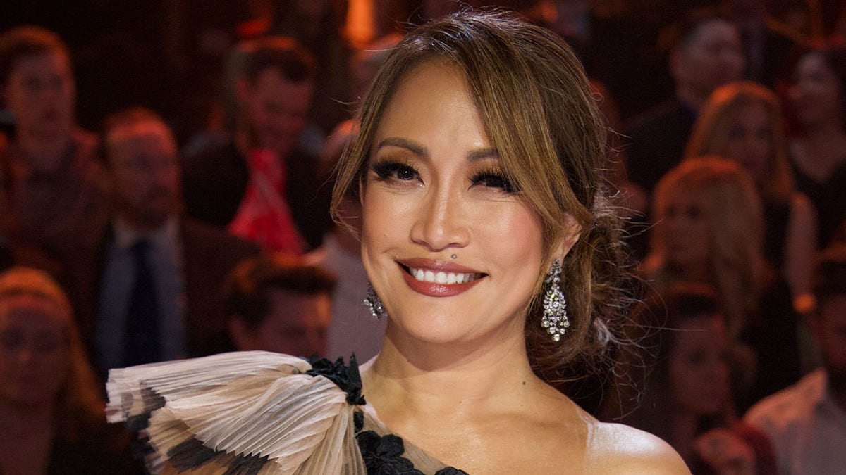 Carrie Ann Inaba smiling on Dancing with the Stars set