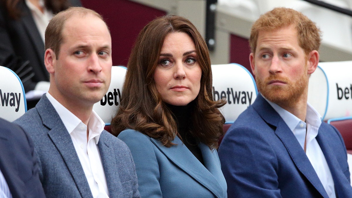 Prince William and Prince Harry standing with Catherine, Duchess of Cambridge at the London Stadium.