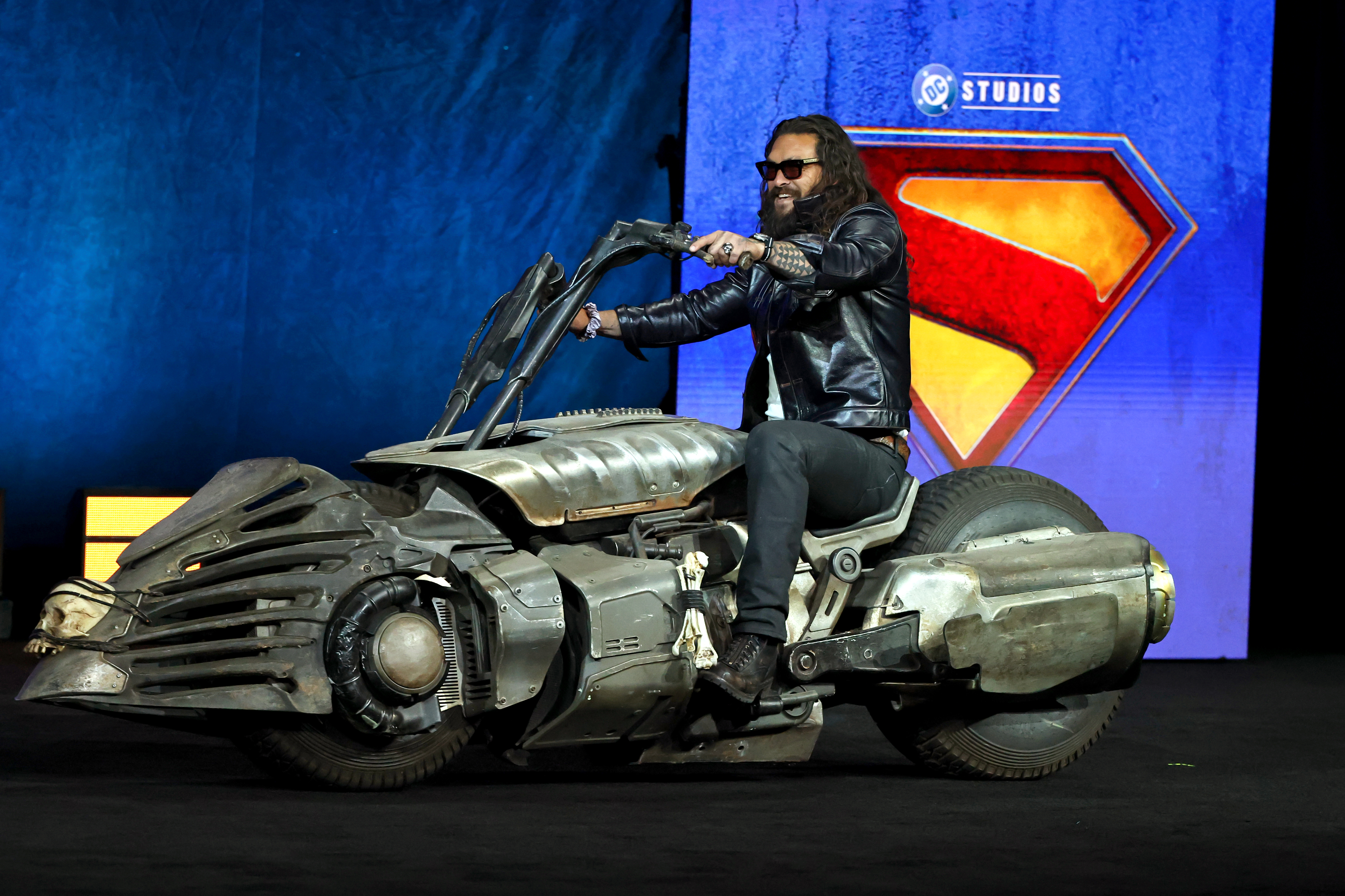 Jason Momoa, who plays Lobo in the “Supergirl” movie, hops on his character’s motorcycle at CinemaCon in Las Vegas.