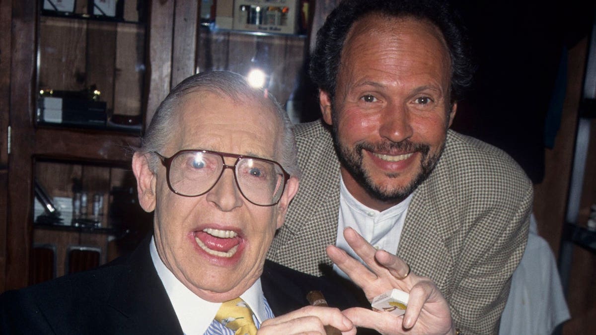 Comedian Milton Berle and actor Billy Crystal smiling together