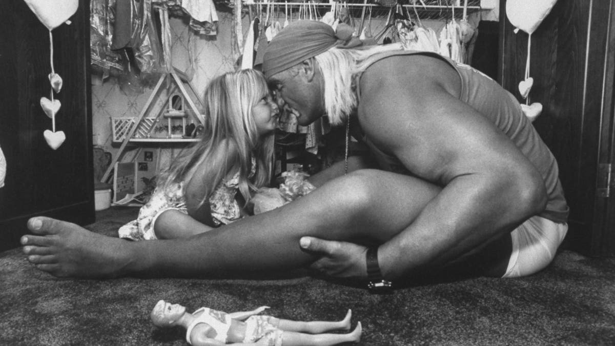 Wrestler Hulk Hogan rubbing noses with his 3-year-old daughter Brooke Bollea at home