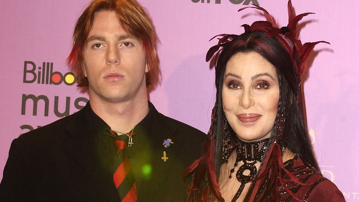 Singer Cher walking red carpet with son Elijah Blue Allman at awards show