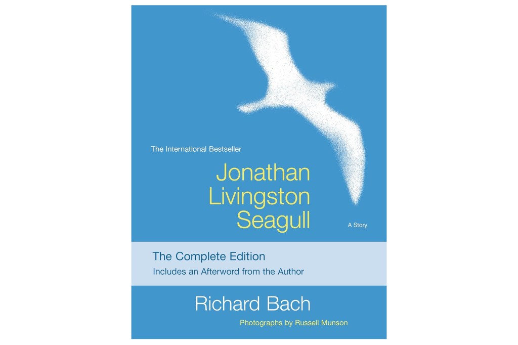 Book cover for "Jonathan Livingston Seagull" by Richard Bach, featuring a white seagull illustration against a blue sky.