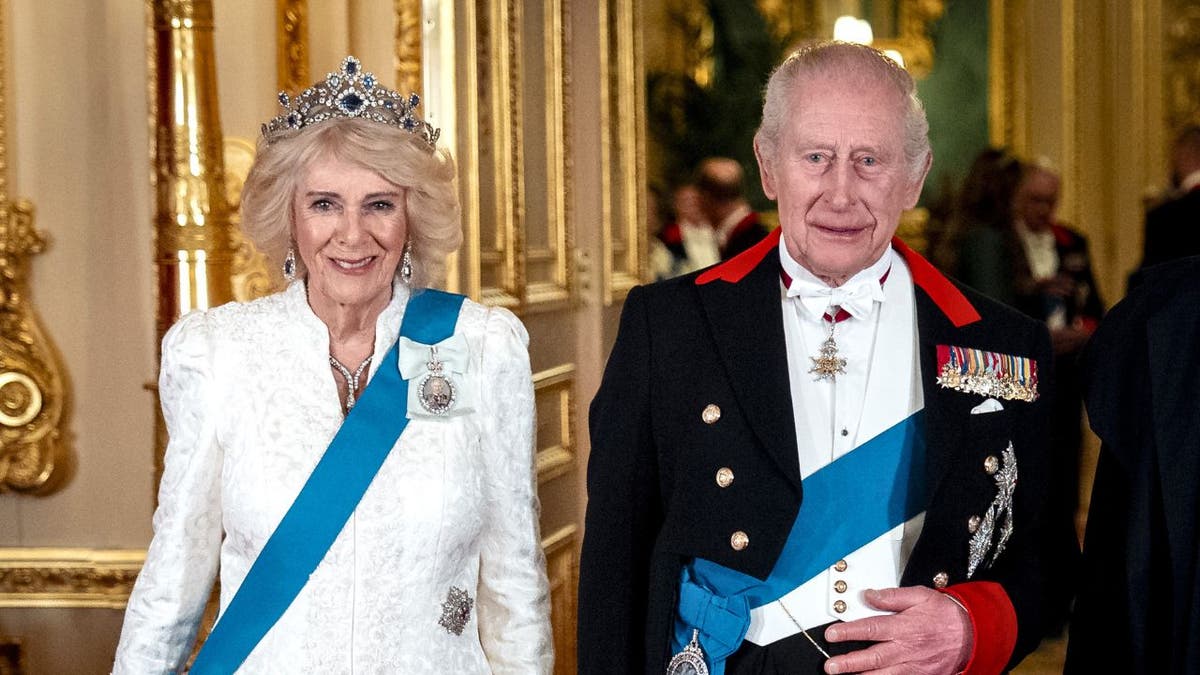 King Charles III and Queen Camilla posing for a photograph at Windsor Castle