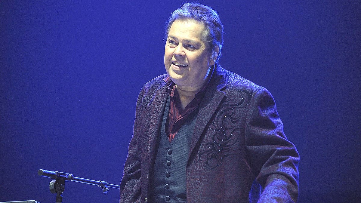 Alan Osmond singing on stage at Wembley Arena in London