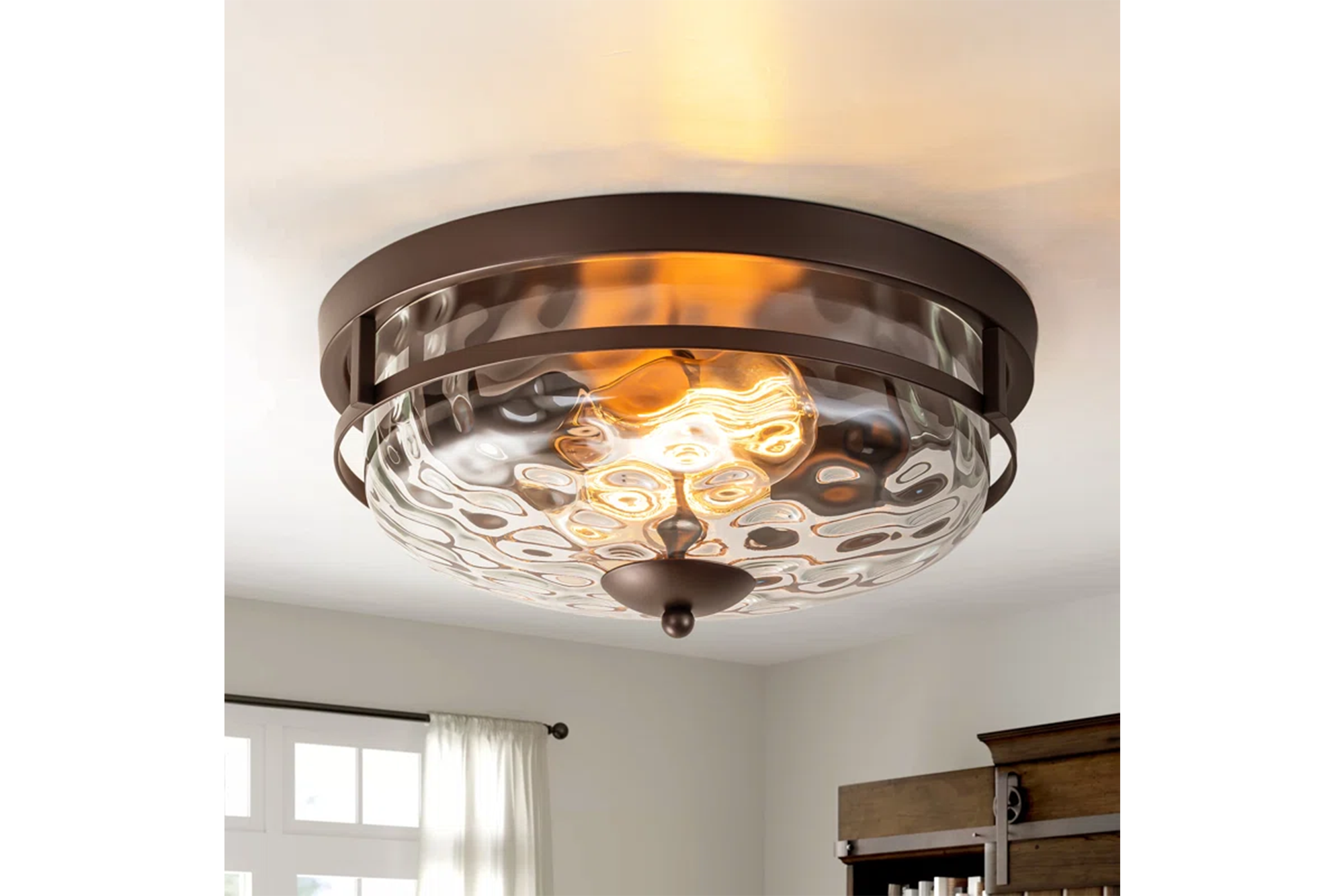 Bronze flush-mount ceiling light with a hammered glass shade.