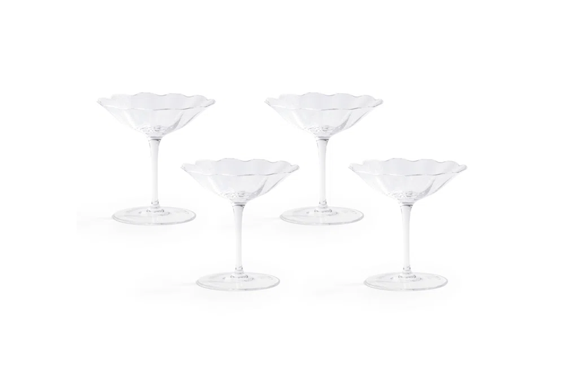 Set of 4 clear glass coupe glasses with scalloped rims.