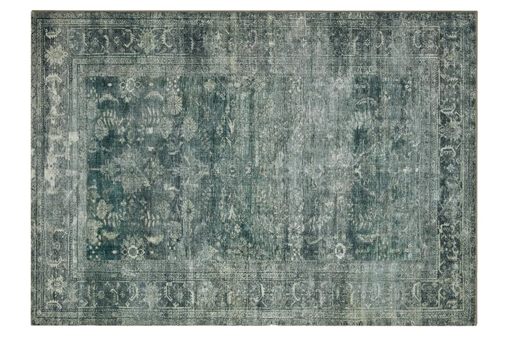Distressed blue and gray area rug with a faded floral pattern and ornate border.