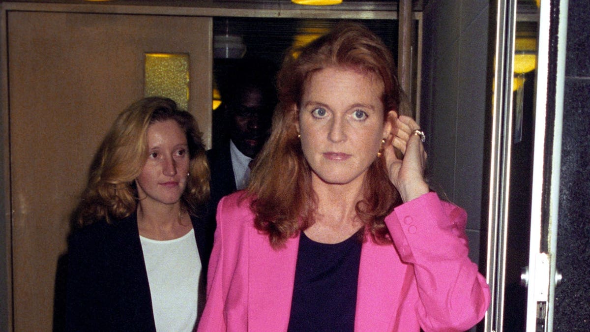 Sarah Duchess of York walking with her dresser Jane Andrews at Heathrow Airport.