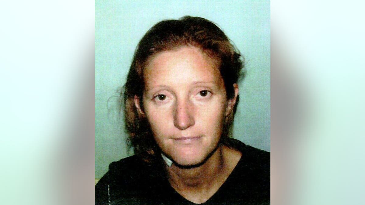 Jane Andrews facing camera in police mugshot.