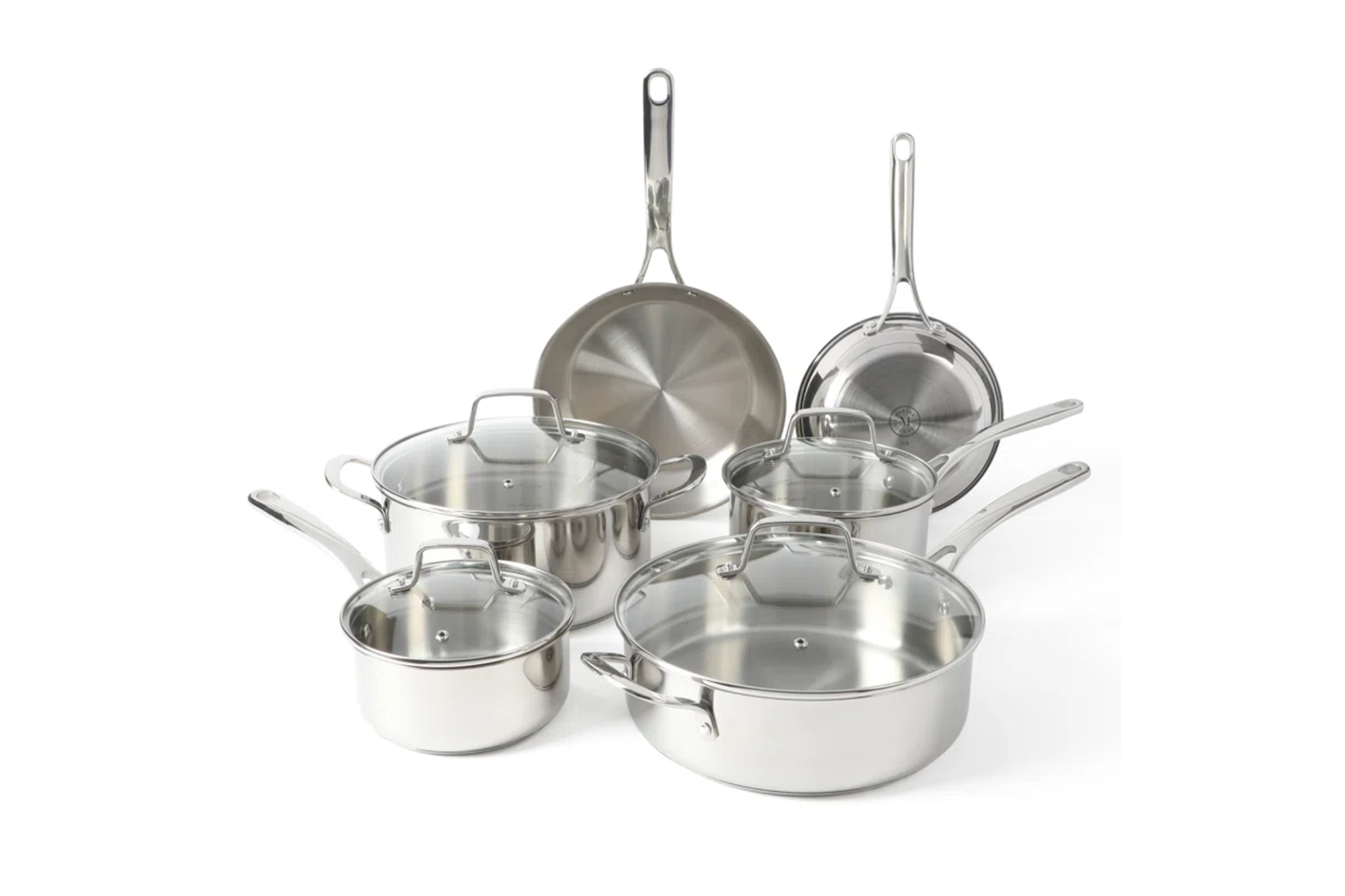 A collection of stainless steel cookware with glass lids.