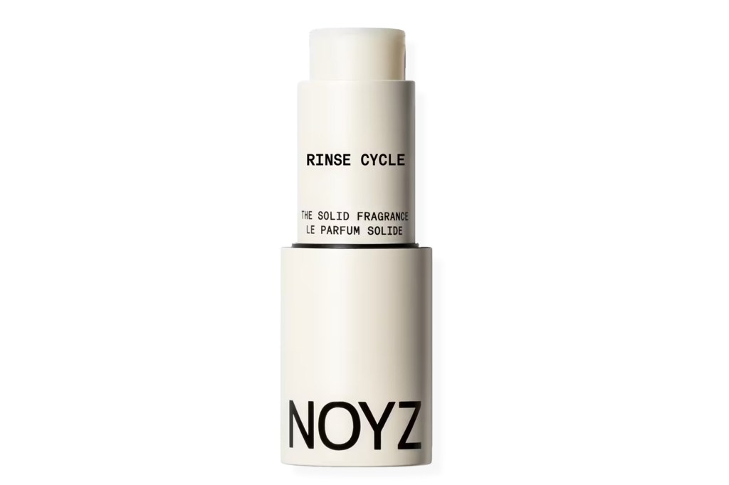 Noyz solid fragrance stick in white, labeled "RINSE CYCLE".