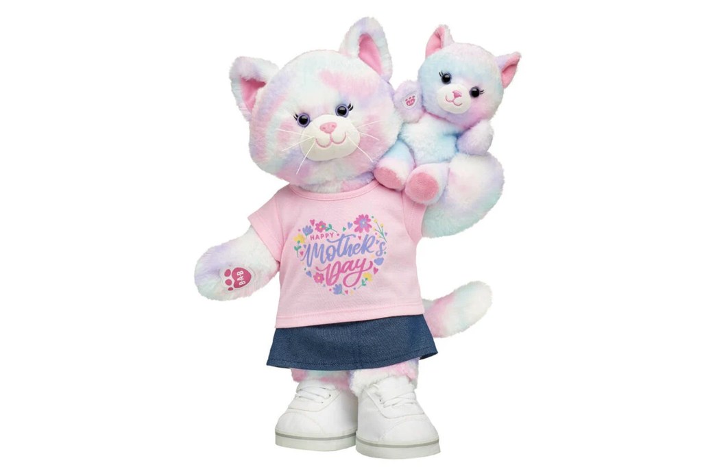 A large pastel cat Build-A-Bear wearing a "Happy Mother's Day" shirt and denim skirt, holding a smaller matching pastel cat plush.