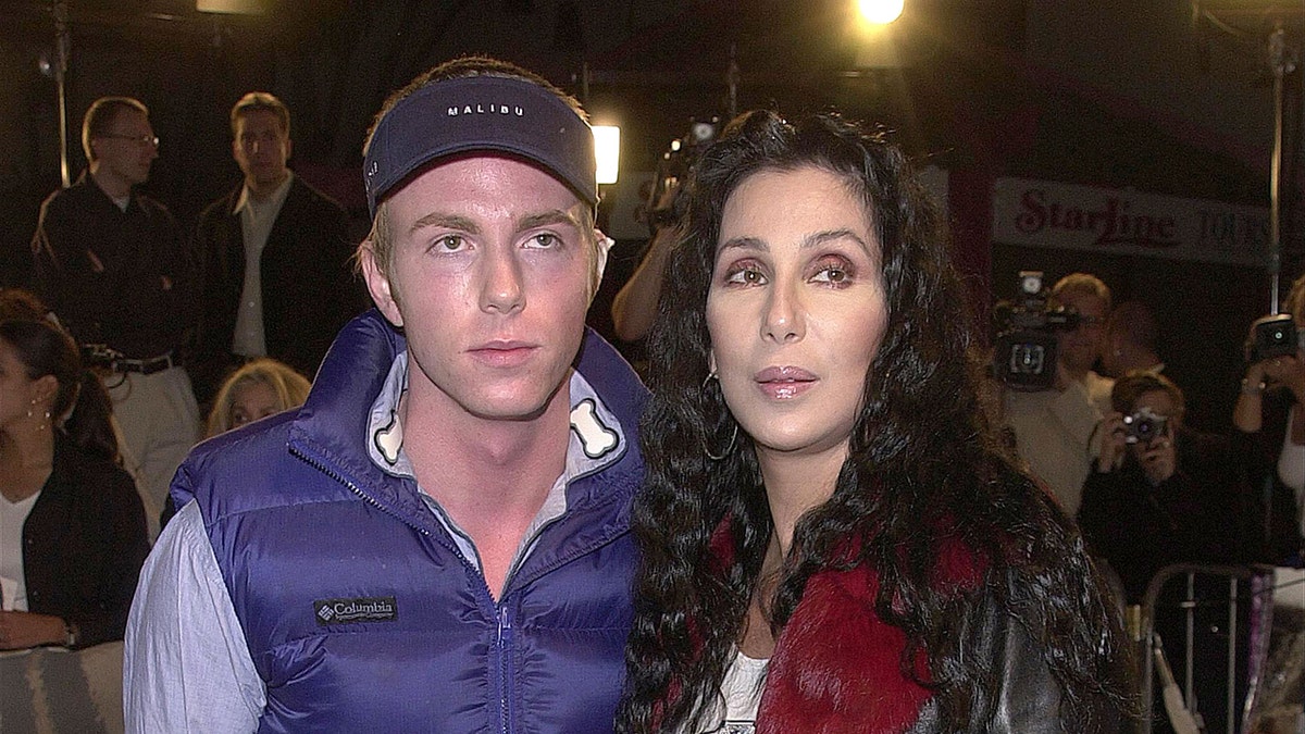 Singer Cher standing with her son Elijah Blue Allman at a Hollywood premiere
