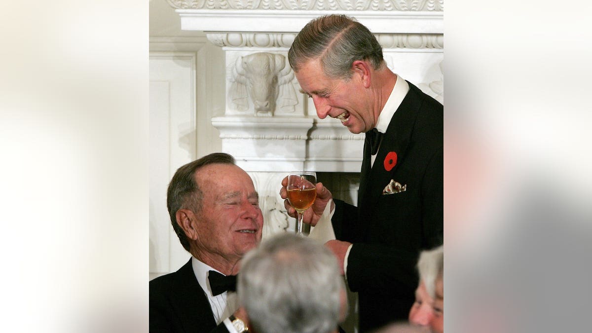 Prince of Wales joking with former President George H. W. Bush at White House dinner.