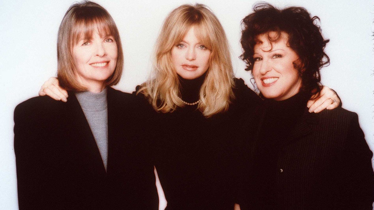 Diane Keaton, Goldie Hawn, and Bette Midler posing together on set