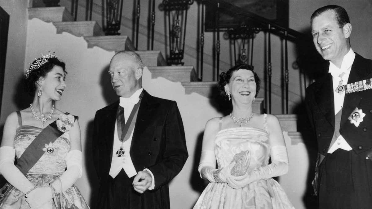 Queen Elizabeth II standing with President Dwight D. Eisenhower, Mamie Eisenhower, and Prince Philip at White House banquet