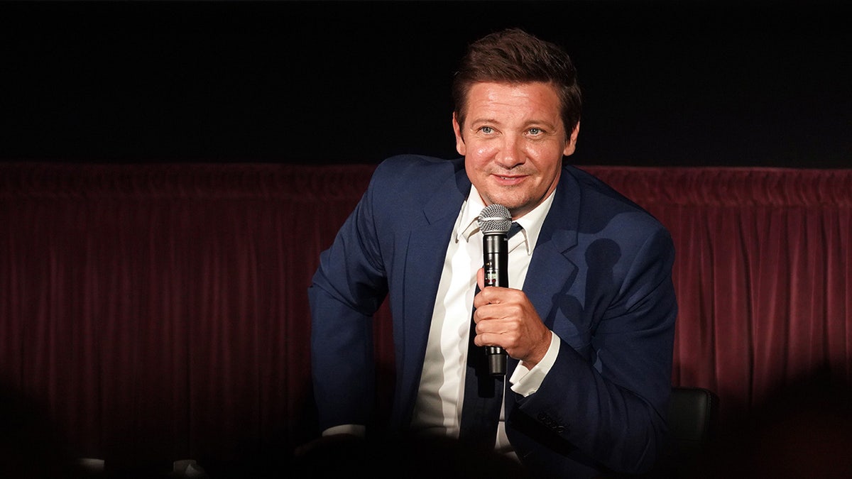 Jeremy Renner speaking onstage at the Rennervations premiere in Los Angeles
