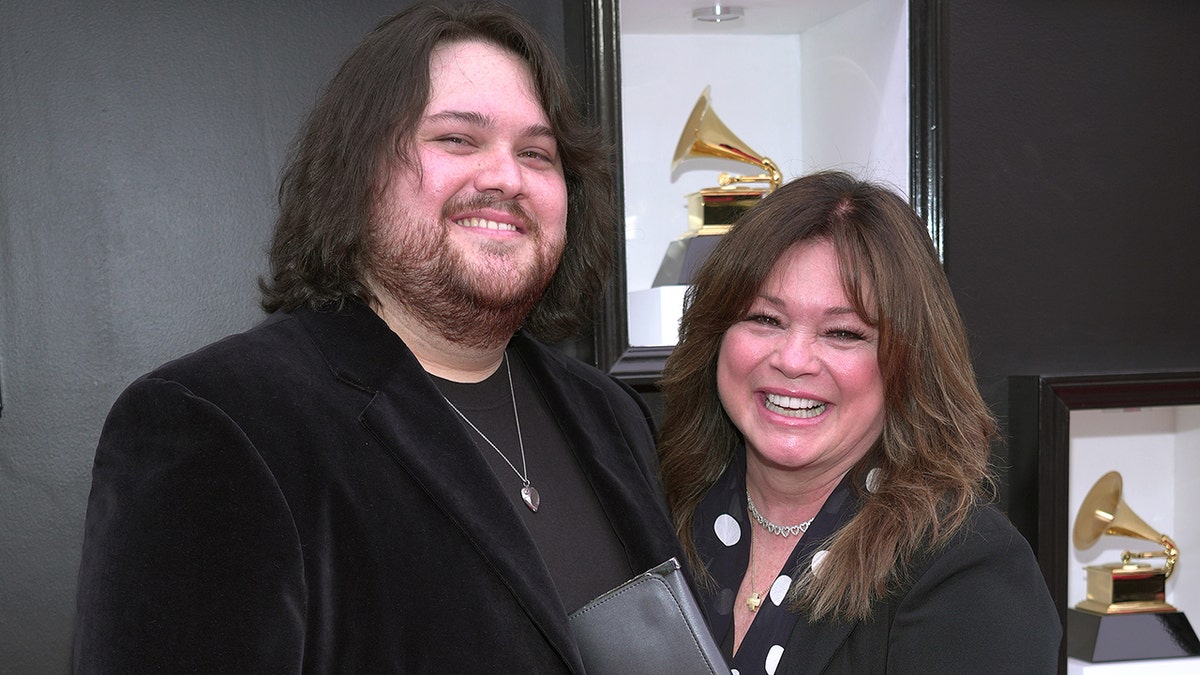 Valerie Bertinelli and her son Wolfgang Van Halen posing together on the Grammy Awards red carpet.