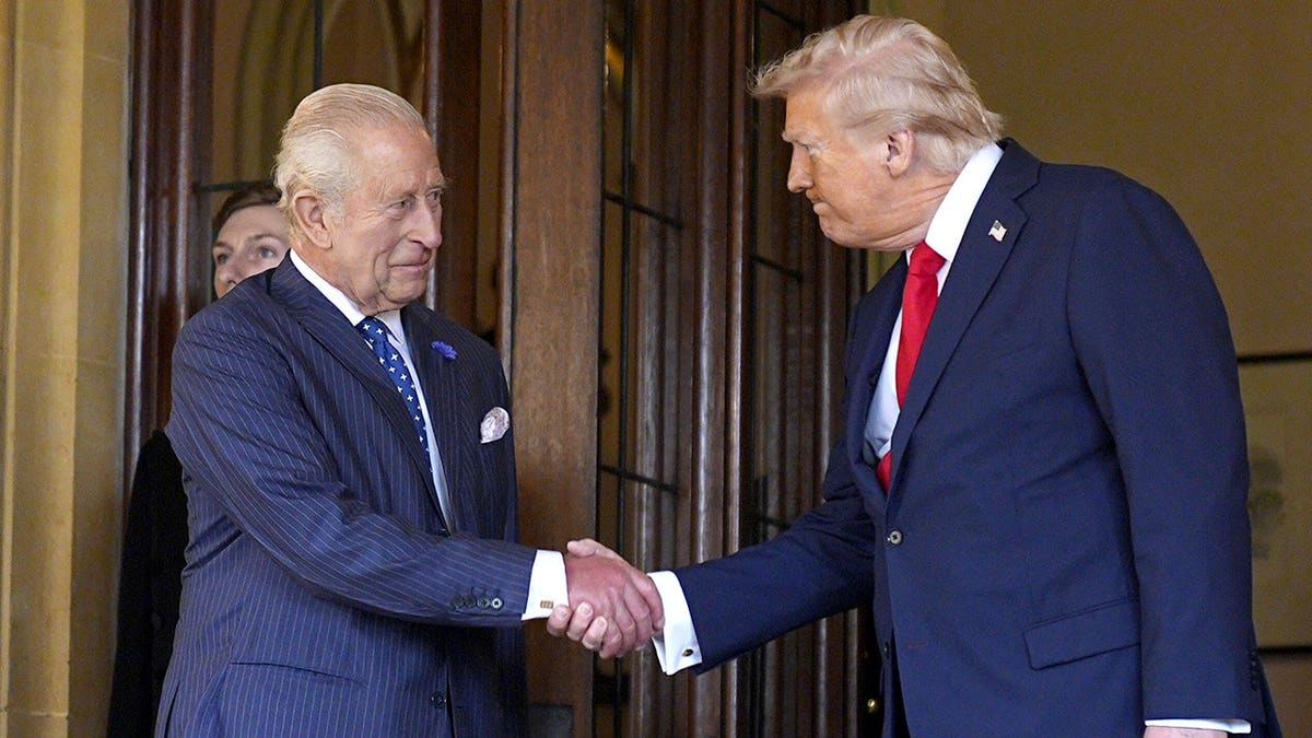 King Charles and President Donald Trump shaking hands.