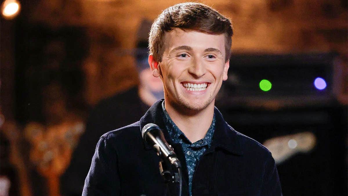 Dylan Carter standing on stage during The Voice battles episode