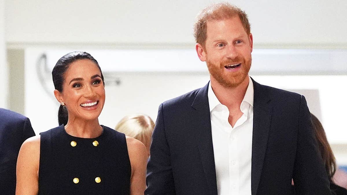 A close-up of Meghan Markle and Prince Harry appearing happy while inside a children's hospital in Australia.