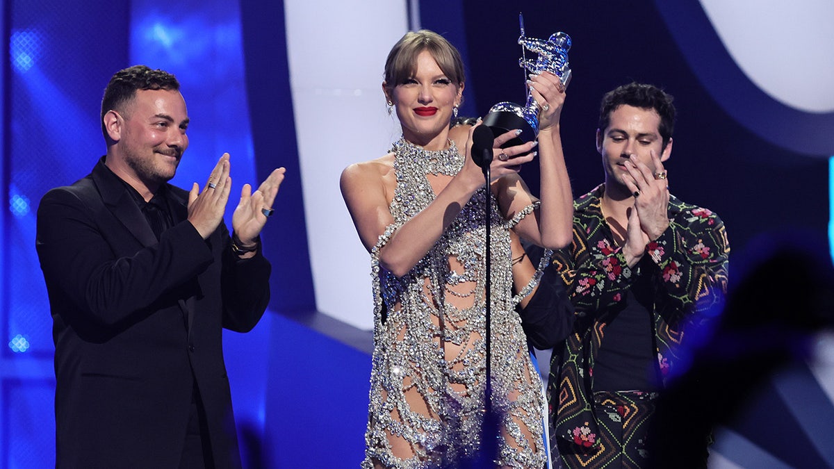 Taylor Swift accepting an award onstage at the 2022 MTV VMAs in Newark, New Jersey