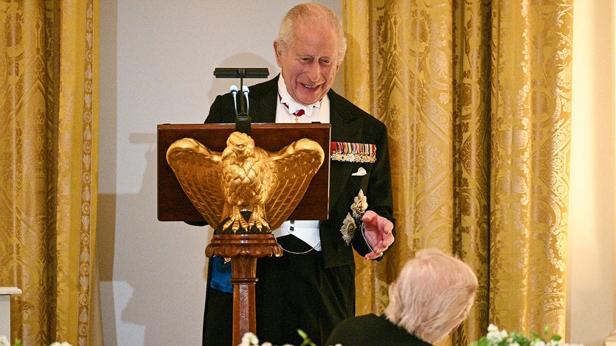 King Charles III speaking as President Donald Trump looks on in the White House East Room