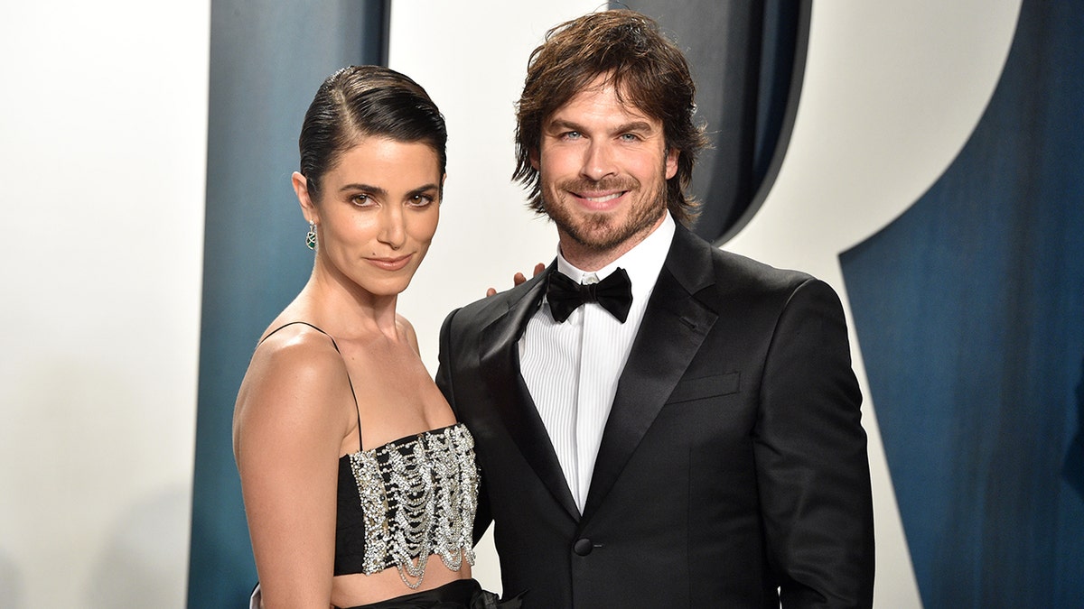 Ian Somerhalder and Nikki Reed posing at Vanity Fair Oscar Party