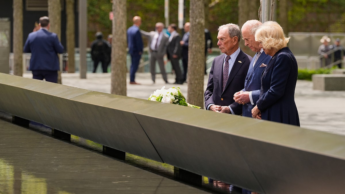 Former New York City mayor Michael Bloomberg walking with Britain's King Charles III and Queen Camilla at the 9/11 Memorial in New York