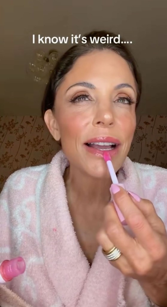 Bethenny Frankel applying pink lip gloss.