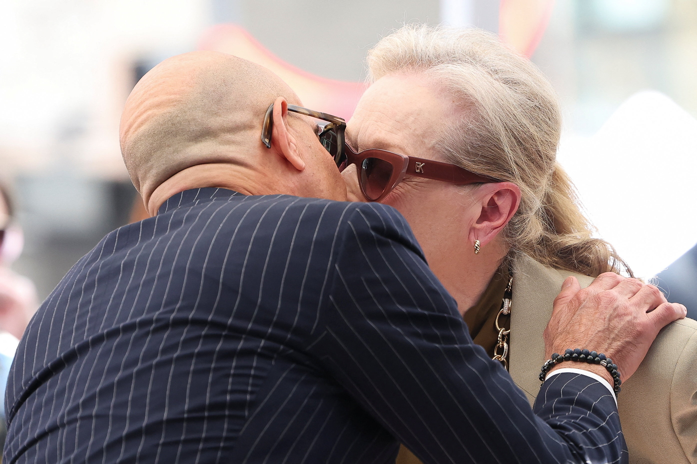 Meryl Streep and Stanley Tucci kiss.