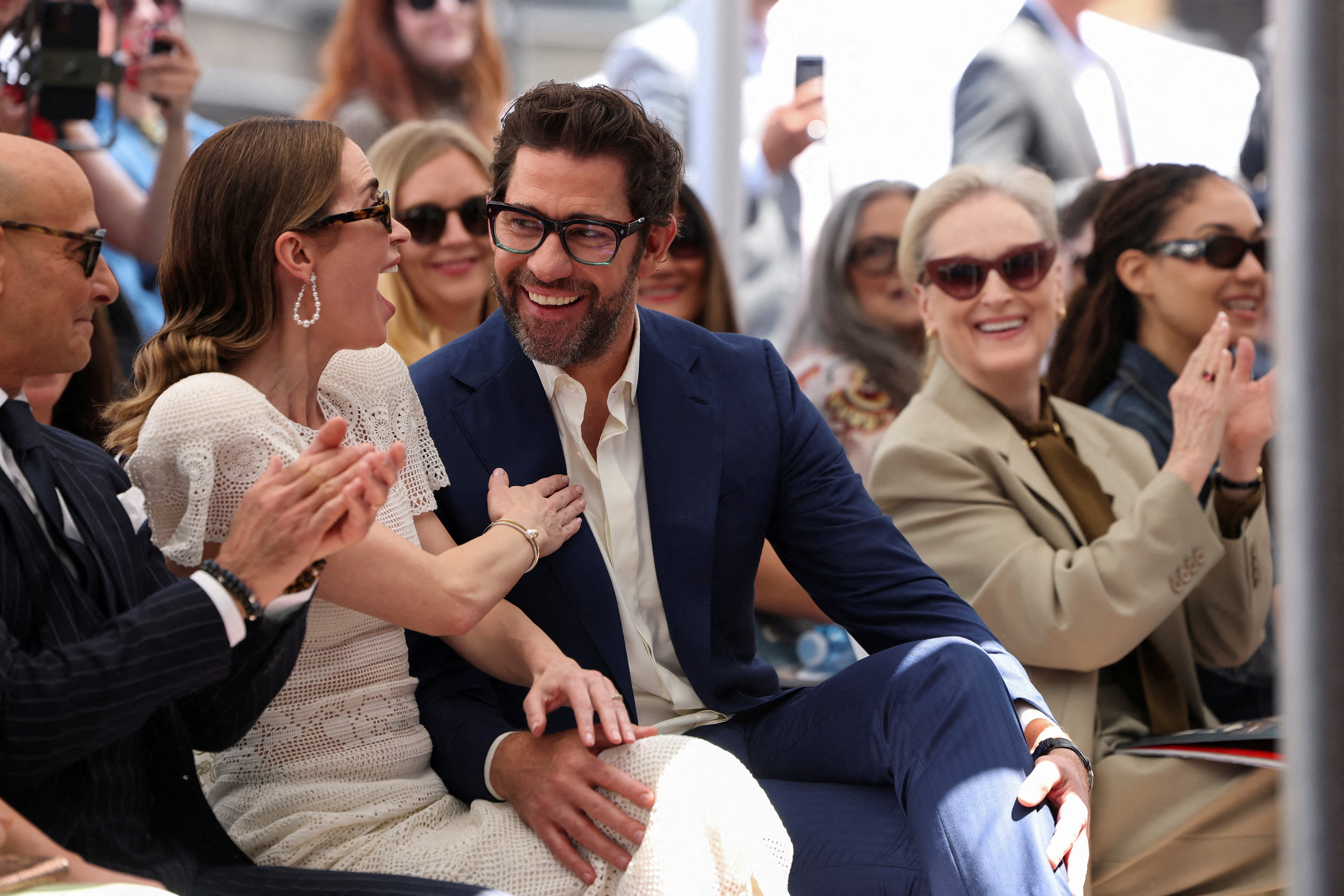 John Krasinski looks at his wife Emily Blunt, next to Stanley Tucci and Meryl Streep, as Blunt and Tucci unveil their stars on the Hollywood Walk of Fame.