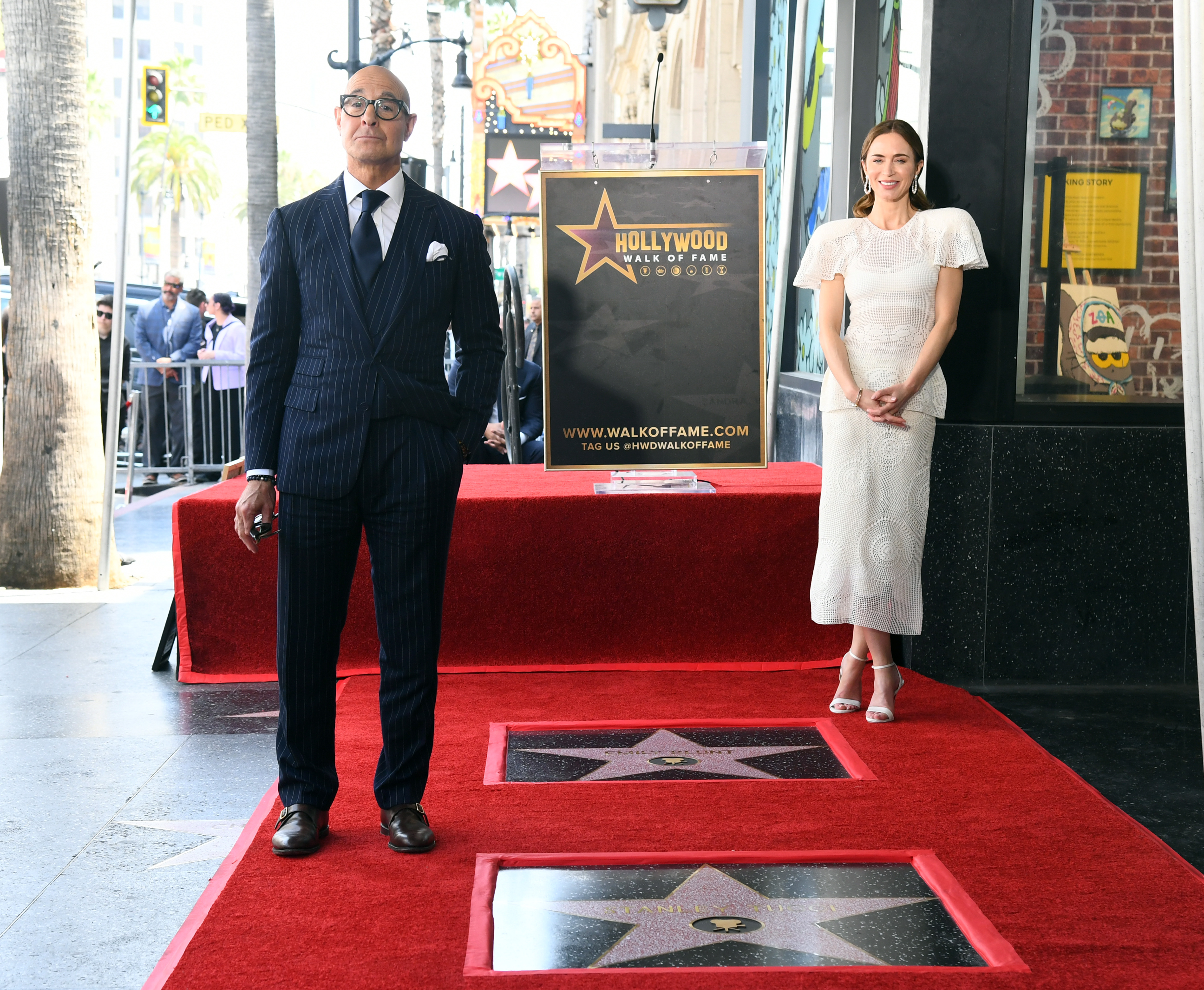 Stanley Tucci and Emily Blunt pose next to their stars during the Hollywood Walk of Fame Star Ceremony 