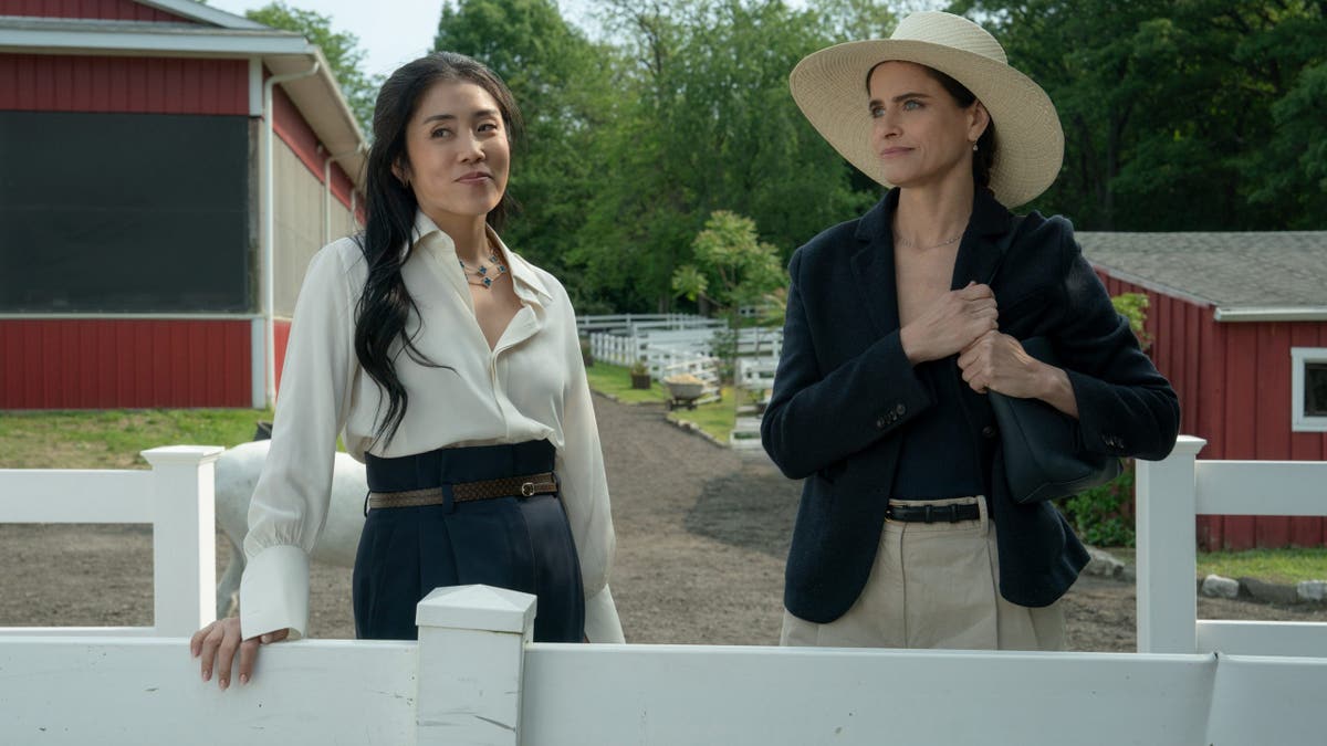 Amanda Peet and Eunice Bae standing together on the set of Your Friends & Neighbors