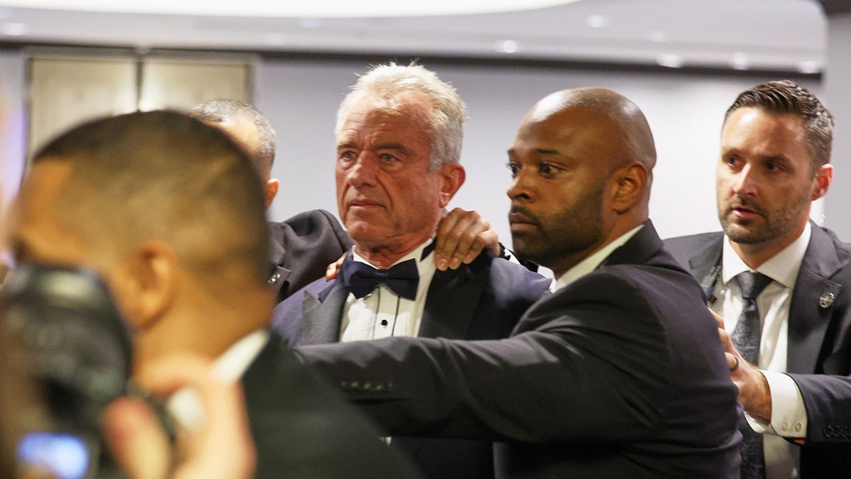 Secretary of Health and Human Services Robert F. Kennedy Jr. being escorted by security at the White House Correspondents Dinner