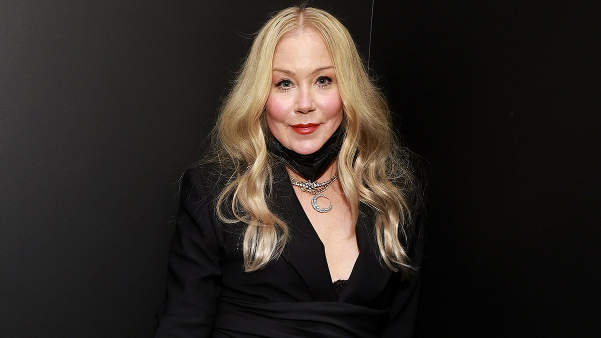 Christina Applegate standing and smiling at an event