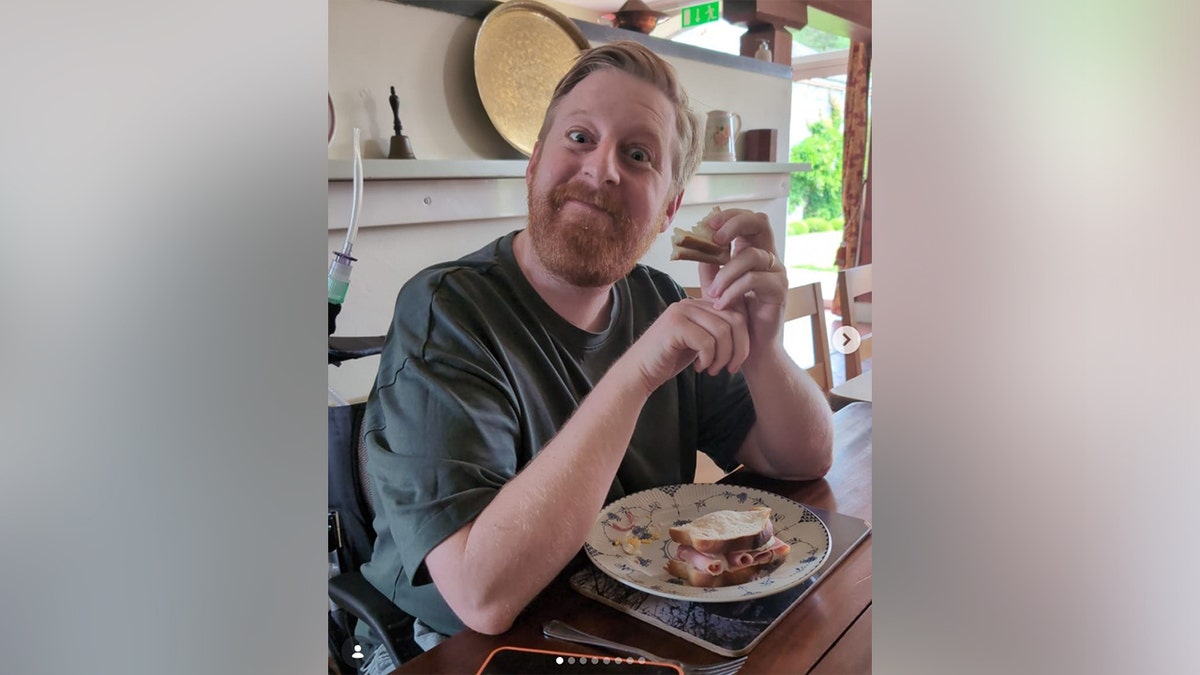 Michael Patrick eating a sandwich.