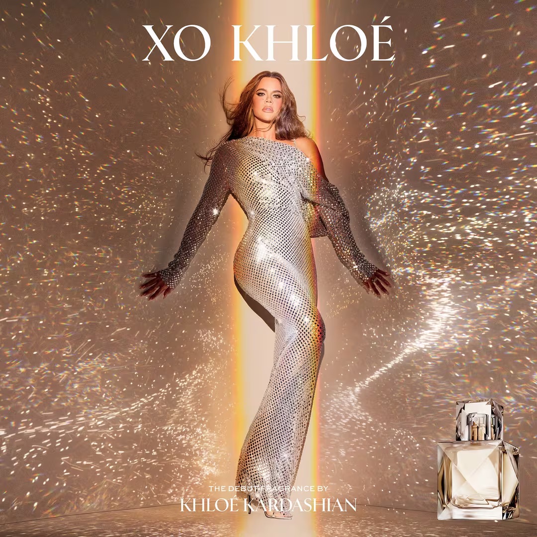 Khloe Kardashian posing in a sparkly dress for the XO Khloé fragrance campaign.