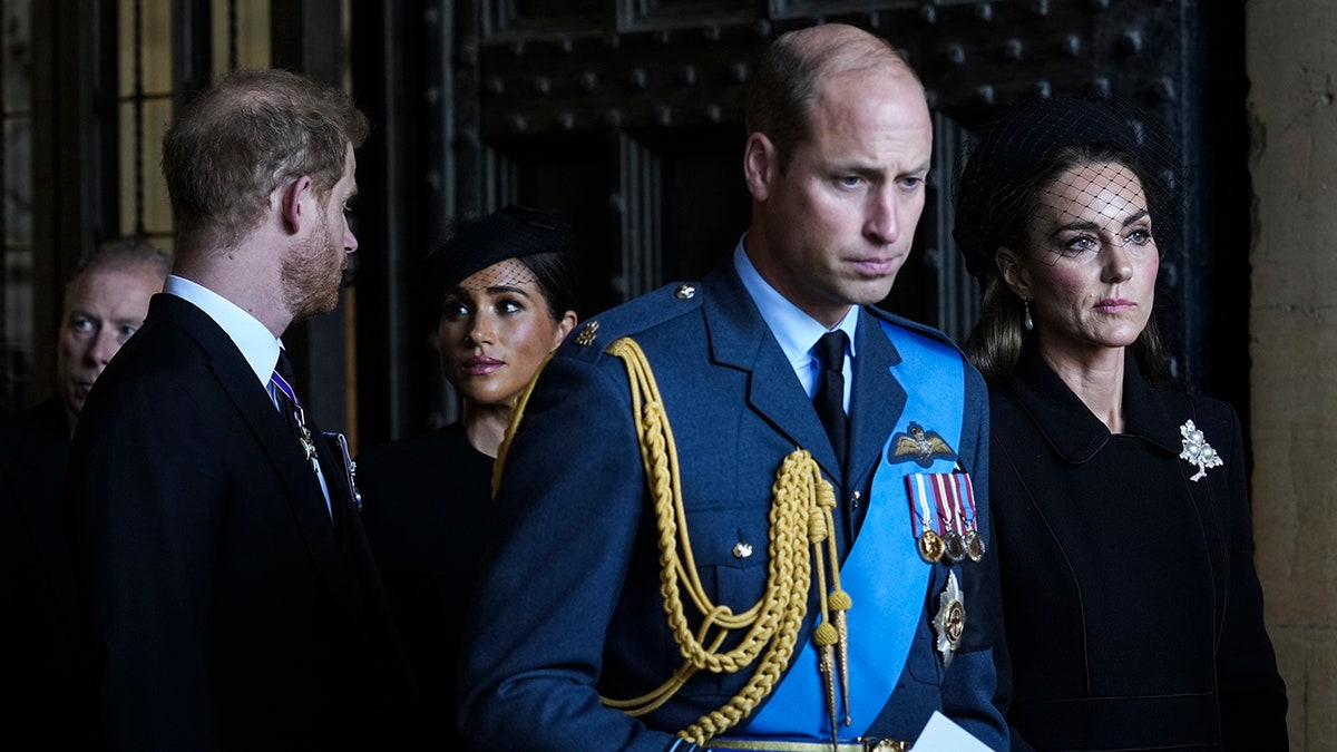 Prince William and Catherine walking ahead of Prince Harry and Meghan leaving Westminster Hall in London