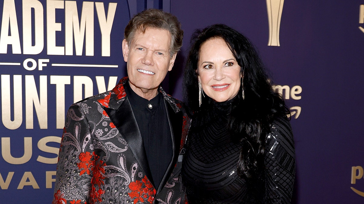 Randy Travis and Mary Davis posing together at ACM Awards in Frisco Texas