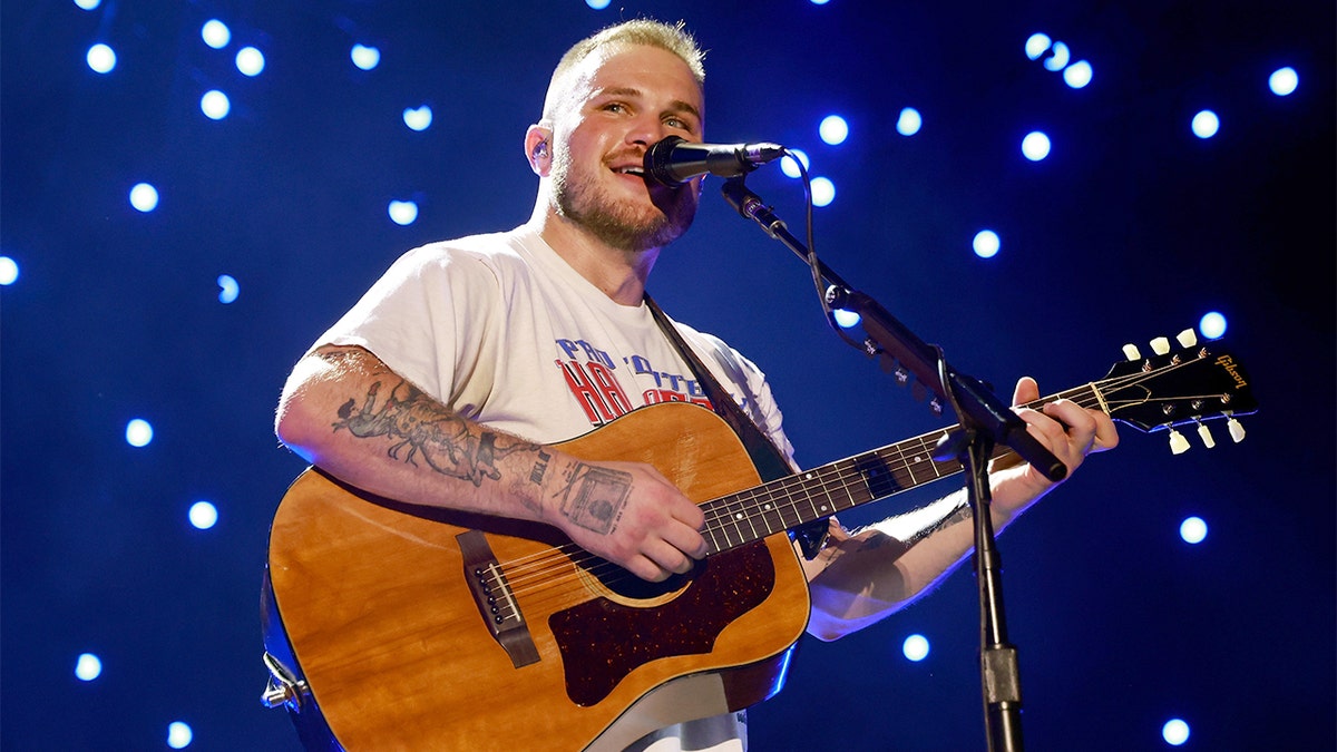 Zach Bryan performing live on stage