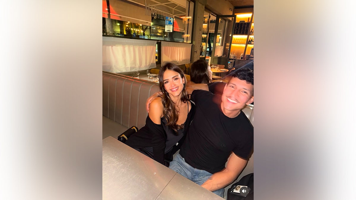 Jessica Alba and Danny Ramirez posing together for a photo