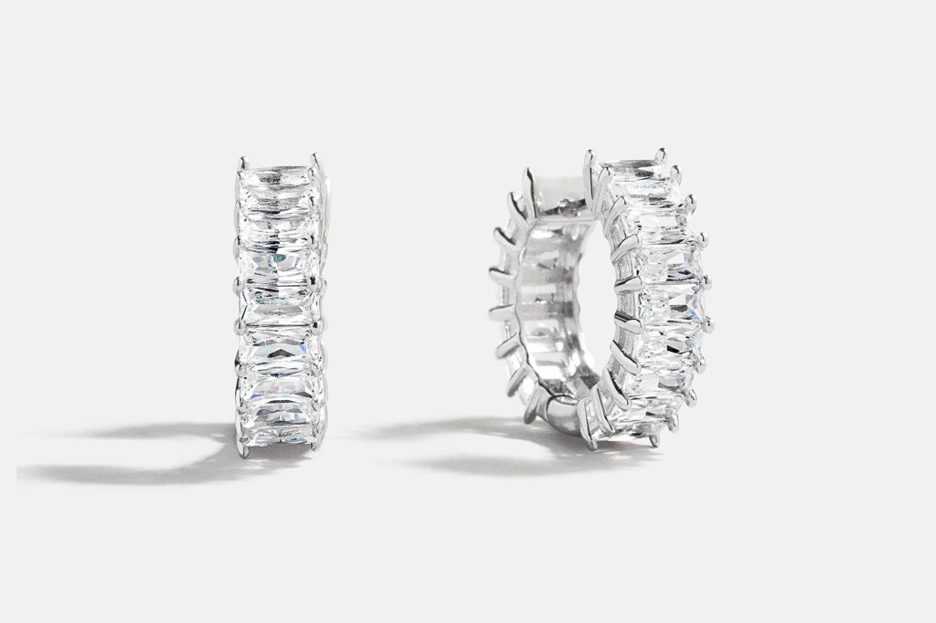 Two silver earrings with baguette-cut crystals.