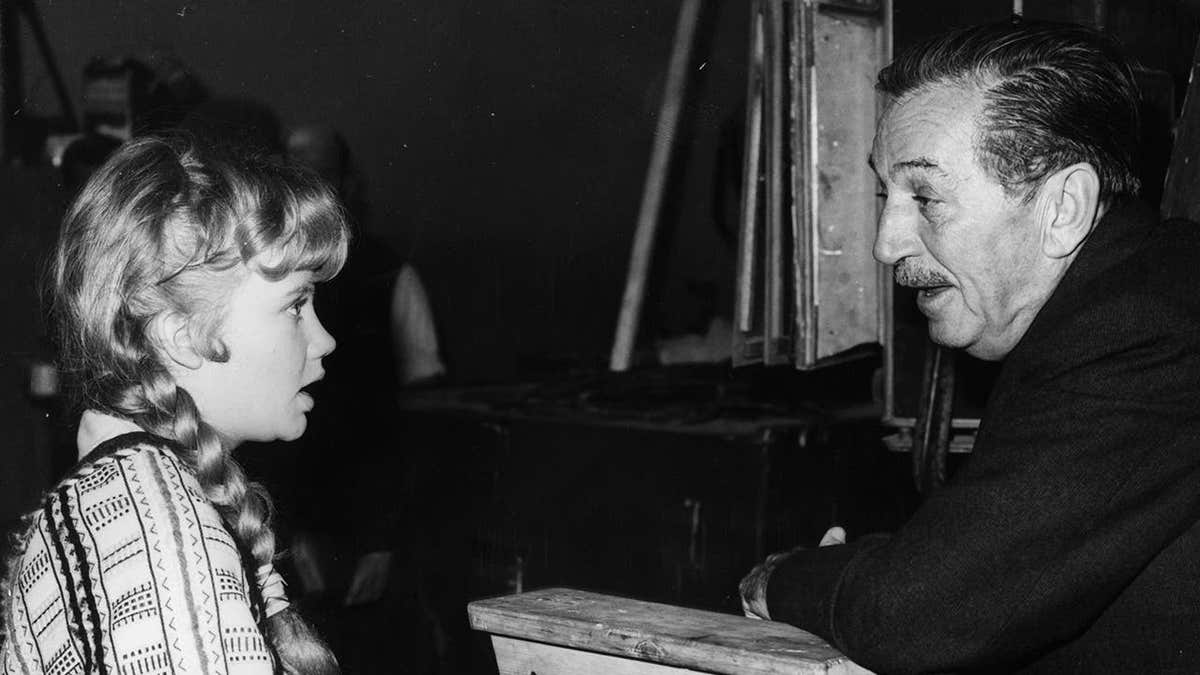Walt Disney talking to Hayley Mills on a film set