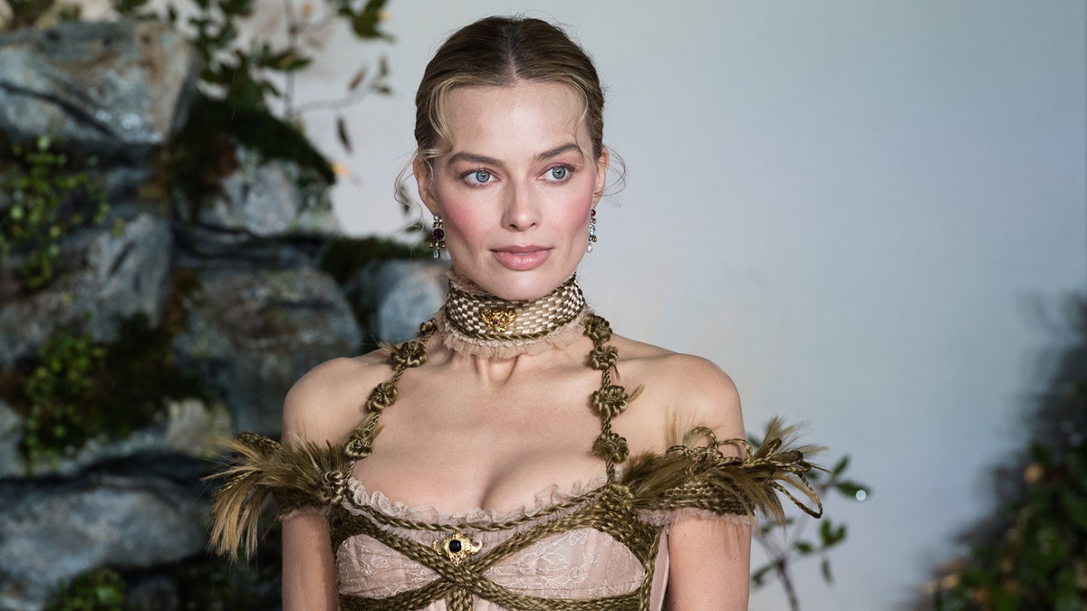 Margot Robbie standing at Odeon Luxe Leicester Square in London