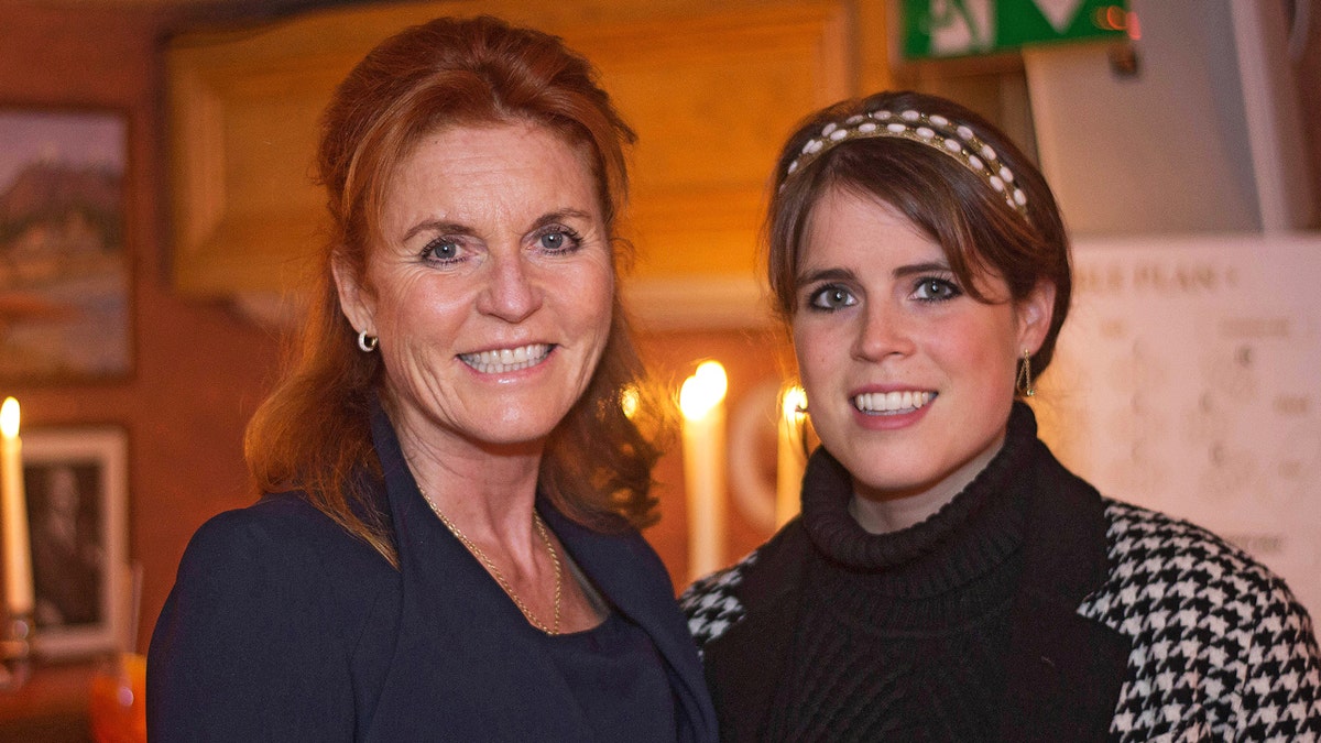 Sarah Ferguson and Princess Eugenie attending a party at an indoor venue.